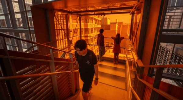 Students walks up the stairs of the GDC