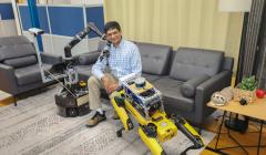 Joydeep posing with robots